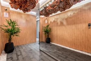 a hallway with two potted plants in a building at Deluxe Apartments in Palermo - by BueRentals in Buenos Aires