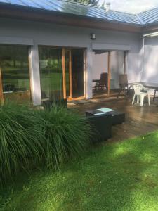 a house with a deck with a table and chairs at Bungalov v Krásné Lípě in Krásná Lípa +16 photos