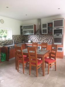 a kitchen with a wooden table and chairs and a kitchen with at Bungalov v Krásné Lípě in Krásná Lípa +19 photos