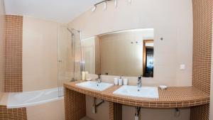 a bathroom with two sinks and a mirror at A&M Apartment Donovaly in Donovaly +16 photos