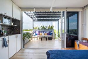 a bedroom with a view of a living room at 3BR Penthouse with Rooftop Pool Near Centro in Tulum