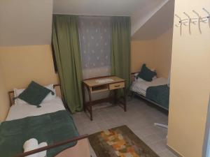 a small room with two beds and a table at Casa Emilia Ana Maria in Recaş