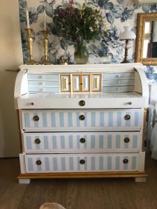 a dresser with a vase on top of it at Hygge in Copenhagen