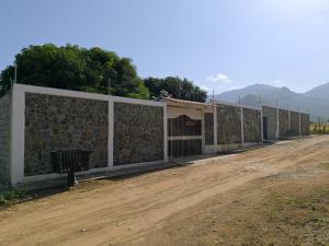 a row of fences on the side of a dirt road at Casa Atenea in Santa Marta