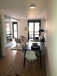 a dining room and living room with a table and chairs at Luxury Apartment in Fuengirola