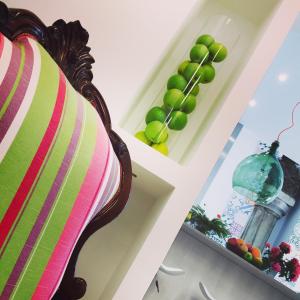 a room with a chair and a shelf of fruit at Sorrento Flats in Sorrento