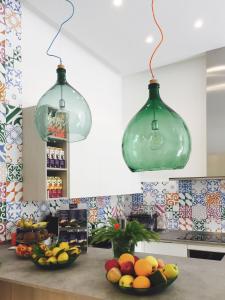 two glass pendant lights hanging over a counter with fruit at Sorrento Flats in Sorrento