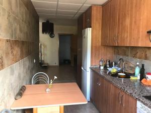 a kitchen with wooden cabinets and a wooden table at El Mirador de Hervas in Hervás +20 photos