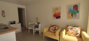 a living room with two chairs and a table at Caparica Studio - Sclusive Stay in Costa da Caparica