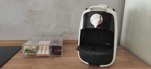 a black and white iron sitting on top of a wooden floor at Caparica Studio - Sclusive Stay in Costa da Caparica