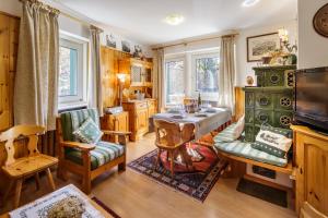 a living room with a table and two chairs at CiasaToa in Cortina dʼAmpezzo