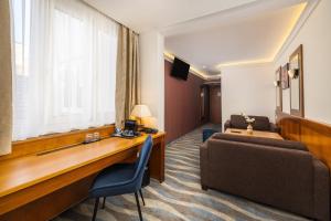 a hotel room with a reception desk and a couch at Carlton Hotel Buda Castle in Budapest