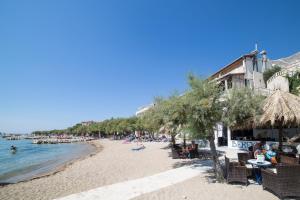 a beach with a lot of people and the water at Villa Nada in Duće