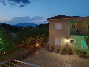 a house with a patio and a balcony at night at Eirini- Ioanna in Sami