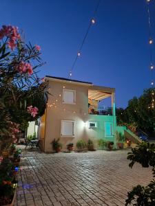 a house with lights on the side of it at Eirini- Ioanna in Sami