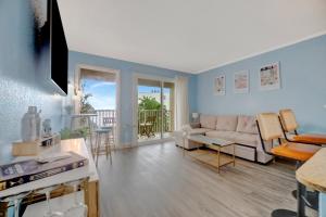 a living room with a couch and a table at Serenity on the Sea Luxury Condo with Private Balcony on the Ocean in Tampa +26 photos