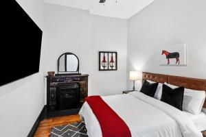 a bedroom with a bed and a tv on a wall at Downtown Kentucky Home Perfect for Groups in Louisville