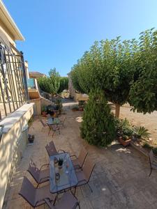 a patio with chairs and a table on a patio at Eirini- Ioanna in Sami