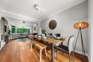 a dining room and living room with a table and chairs at Luxury 3-BR Home-Driveway, Sky-TV-Fast WiFi in Meanwood