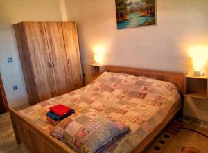 a bedroom with a bed with a red bag on it at Apartman Potocki in Krapina