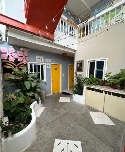 a hallway of a building with yellow doors and plants at Chescos Hotel in Salinas +21 photos