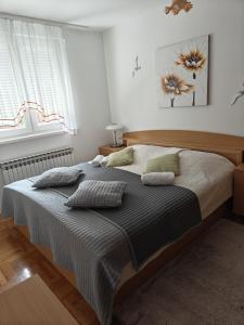a bedroom with a large bed with pillows on it at Apartment Meli Varazdin in Varaždin +37 photos