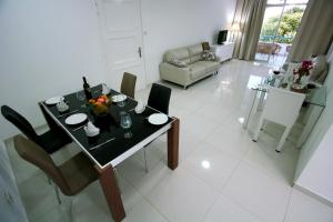 a dining table and chairs in a living room at Pissouri Beach Apartments in Pissouri