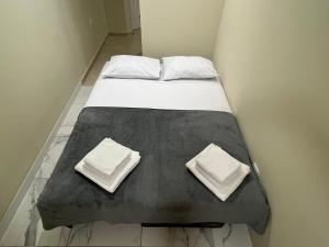 a bed with two pillows on top of it at Lucky center Apartment in Podgorica +2 photos