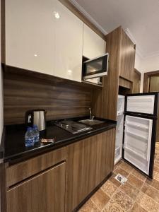 a kitchen with a stove and a refrigerator at 1 Antica Jabalal-lwebdeh in Amman