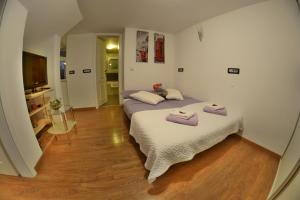 Postel nebo postele na pokoji v ubytování Apartment Arpa