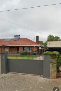 a house with a gate and a fence at 20 Ernest self catering in Beaconsfield