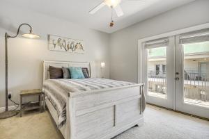 a bedroom with a bed and a window at Biloxi Condo with Community Pool about Half-Mi to Beach! in Biloxi +19 photos