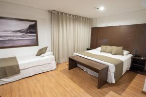Postel nebo postele na pokoji v ubytování Olavo Bilac Hotel