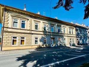 a large brick building on the side of a street at Apartmán na Žerotínce in Šumperk