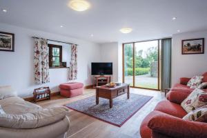 a living room with two couches and a tv at The Stables - 3 Bedroom Cottage - Beavers Hill in Manorbier