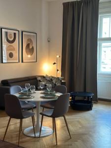 a living room with a table with wine glasses on it at Spacious Elegance - A Central Gem in Prague