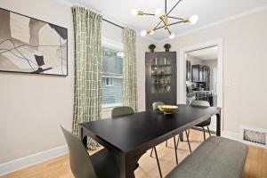 a dining room with a black table and chairs at Cozy Mid Century Oasis with 2 KING beds in Peoria