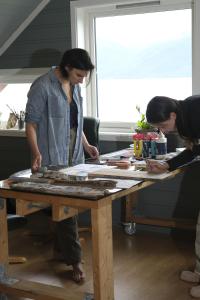 two women standing around a wooden table at 3ART recreation in Tromsø