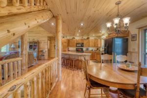 a dining room and kitchen with a large wooden table at Montana Mountain Getaway in Creston