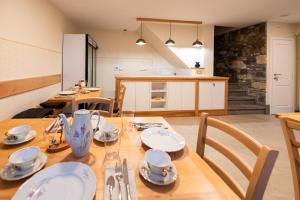 a kitchen and dining room with a table and chairs at 4 TeTE in Vrhpolje