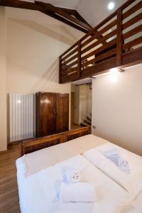 a bedroom with a bed with two towels on it at 4 TeTE in Vrhpolje