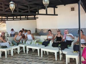 a group of women sitting on couches in a room at Wadi Rum Majestic Camp in Wadi Rum