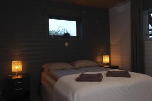 a bedroom with a bed with two towels on it at 3ART recreation in Tromsø