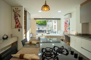a kitchen with a table with a giraffe on the wall at 201 Norte cali - The View in Cali