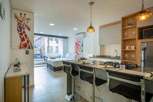 a kitchen with a giraffe painting on the wall at 201 Norte cali - The View in Cali +15 photos