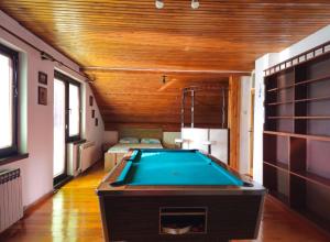 a pool table in the middle of a room at Peaceful Vacation Villa & Garden in Sarajevo
