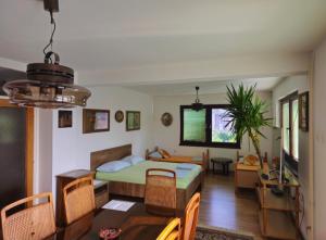 a bedroom with a bed and a dining room at Peaceful Vacation Villa & Garden in Sarajevo