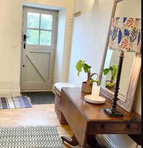 a room with a mirror and a table with a lamp at Hob Lane Farm Cottage - Peak Park in Oughtibridge