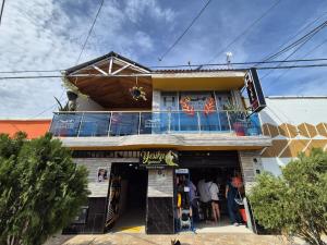 a store front of a building with a balcony at Casa Hotel Diana Luz in Villavieja