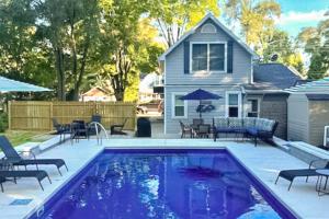 a swimming pool in front of a house at Merchant Street Retreat in New Buffalo